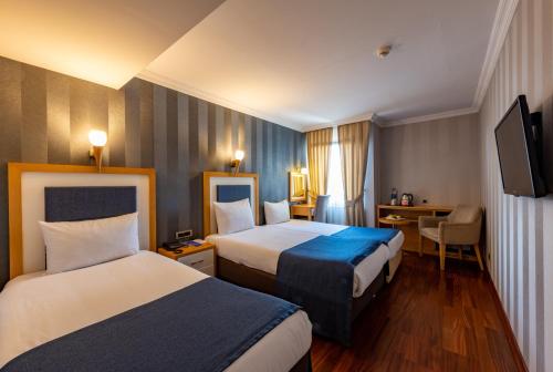 A bed or beds in a room at Nova Plaza Taksim Square