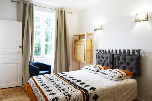 a bedroom with a bed and a window at VILLA EPERONNIERE in Nantes