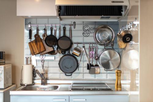 a kitchen with pots and pans hanging on the wall at SORAPIA Villa Mt.FUJI Front in Fujikawaguchiko