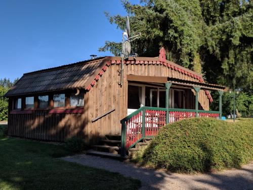 a small wooden house with a red roof at Chalets des Trois Hêtres in Plombières-les-Bains