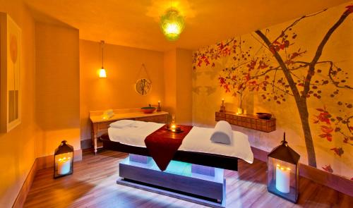 a room with two beds and a table and lights at Titanic Deluxe Lara in Lara