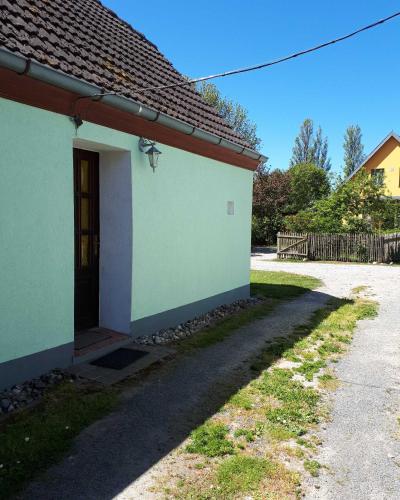 a white building with a door and a driveway at Haus Ebel in Putgarten