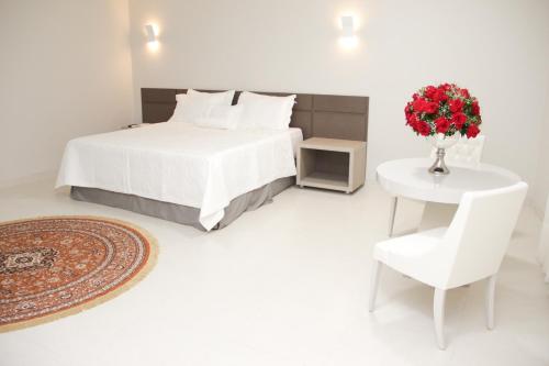 מיטה או מיטות בחדר ב-Gran Park Hotel e Convenções