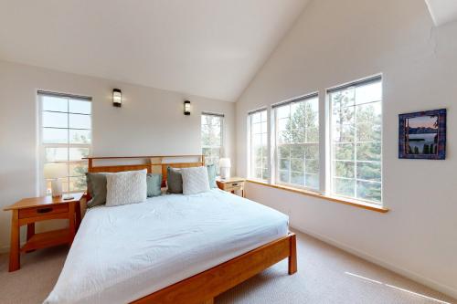 a bedroom with a bed and two windows at Valhalla in Truckee