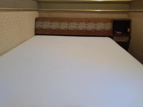 Postel nebo postele na pokoji v ubytování The LEY HOTEL 寶麗頌旅館
