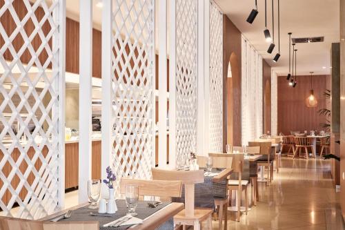 a restaurant with wooden walls and tables and chairs at Atlantica Marmari Palace in Mastichari