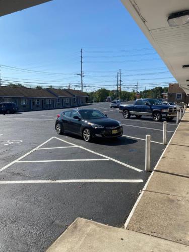 a black car parked in a parking lot at Bel Air Motor Lodge in Maple Shade
