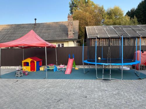 a playground with play equipment and a tent at Casa cu Flori Moisei in Moisei