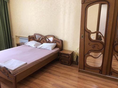 a bedroom with a bed and a large mirror at Elit Aparts on Puskina WIFI in Dnipro