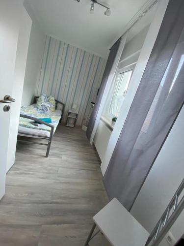 a small room with a bed and a window at Ferienhaus Thalia 1 in Übach-Palenberg