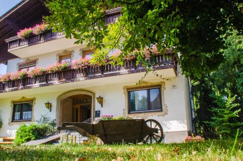 a house with a cart in front of it at Frühstückspension Helmhof in Salzburg