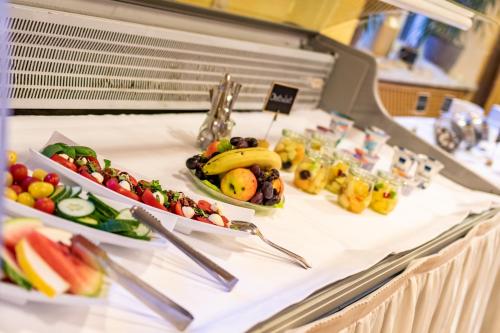 a buffet with fruits and vegetables on a table at Hotel Goldflair am Rathaus in Korbach