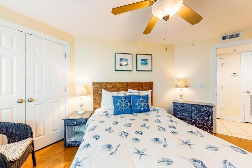 a bedroom with a bed and a ceiling fan at Tybee Escape in Tybee Island