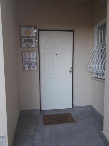 a white door in a room with a tile floor at b&b Il Sorriso in Pozzilli