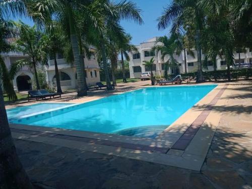 a large swimming pool in front of a building at B2 Royal Palm apartments - Mtwapa in Mtwapa