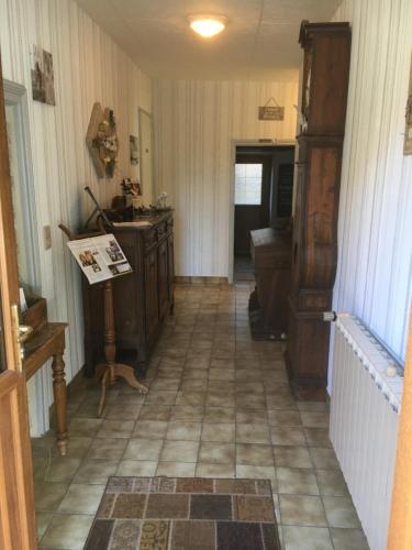 a hallway of a home with a tile floor at Centre Sérénité au Coeur du Limousin in Fromental