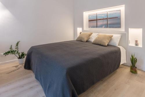 a bedroom with a large bed with a window at Residence La Torre con private park in Trieste