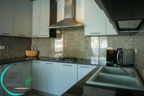 a kitchen with white cabinets and a sink at OCEAN VIEW! LUX PENTHOUSE 3Br, 3Bt, POOL VIEW in Punta Cana
