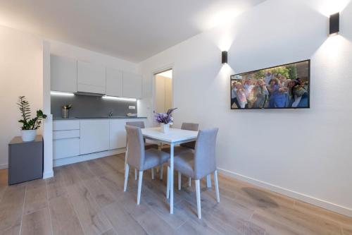 a kitchen and dining room with a table and chairs at Residence La Torre con private park in Trieste