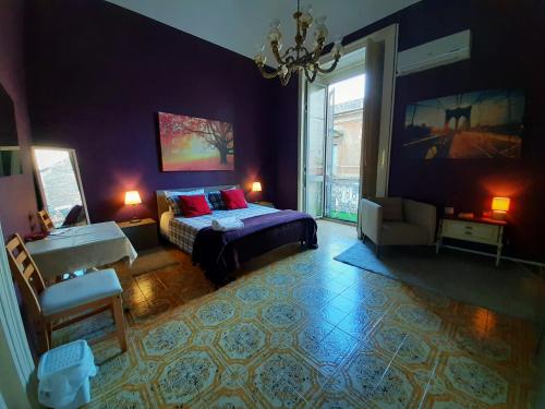 a bedroom with a bed and a large window at Dream 117 in Catania