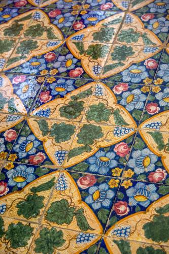 a close up of a tile floor with flowers on it at Relais Antica Napoli in Naples