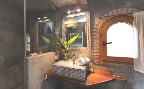 a bathroom with a sink and a table and a mirror at Can Caponet in Lliçà d'Amunt
