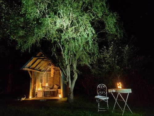 a tree and a table and a chair next to a tree at The Granary in Ruthin