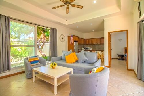 a living room with a couch and chairs and a table at VIEW TALAY VILLAs POOL 155, JOMTIEN BEACH, PATTAYA in Jomtien Beach