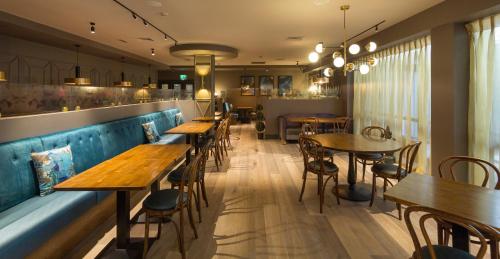 a row of tables and chairs in a restaurant at Limerick City Hotel in Limerick