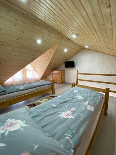 a bedroom with two beds in a attic at Апартаменти Золота Баня 5 in Skhidnitsa