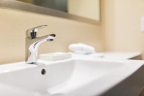 a bathroom sink with a faucet on top of it at Hotel Chateau Laurier Québec in Quebec City