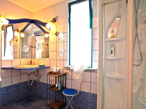 a bathroom with a shower and a sink and a mirror at Hotel Scapolatiello in Cava deʼ Tirreni