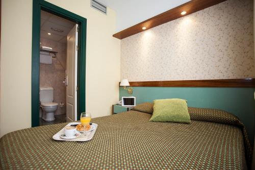 Ένα ή περισσότερα κρεβάτια σε δωμάτιο στο Hotel Jardín de Aranjuez