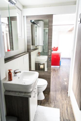 a bathroom with a white sink and a toilet at Floating House Sea Queen in Portorož