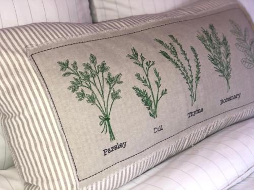 a blanket with parsley on top of a couch at Sun Terrace Lodge Weybridge in Oatlands Park