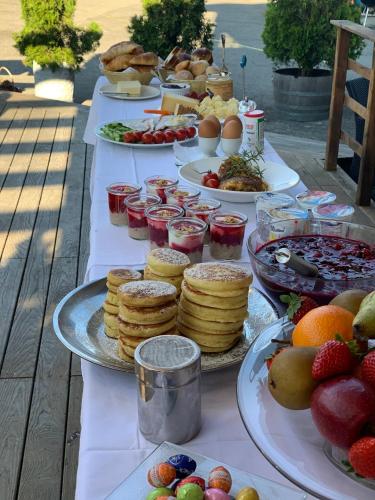 a table filled with plates of food and fruit at Gasthof Hirschen in Oey