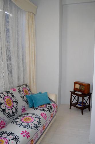 a living room with a couch and a table at Cunda Adali Pansiyon in Ayvalık