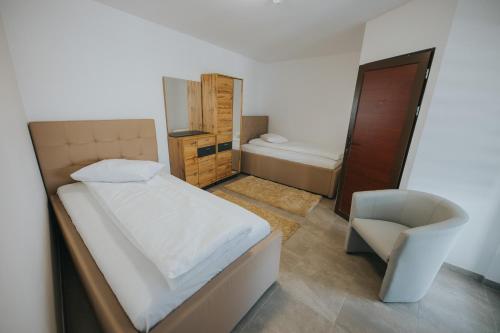 a small bedroom with a bed and a chair at Endlich zuhause in Sibiu