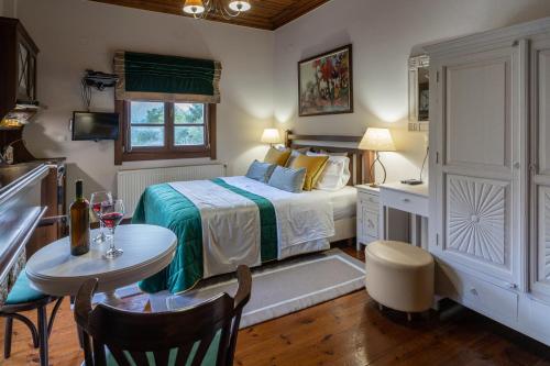 a bedroom with a bed and a table and chairs at Studio Iviscos in Mikrón Khoríon