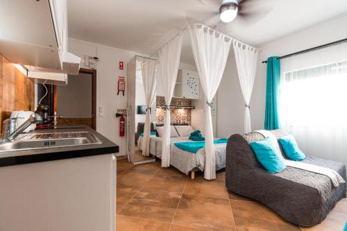 a kitchen with two beds in a room at Casa Alegria by CosyCasa Praia Peniche in Peniche