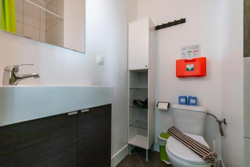 a bathroom with a toilet and a sink at Casa Alegria by CosyCasa Praia Peniche in Peniche
