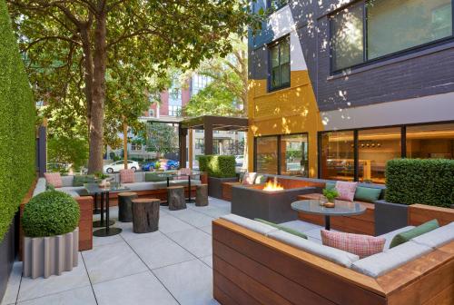 a patio with couches and tables and trees at Viceroy Washington DC in Washington, D.C.