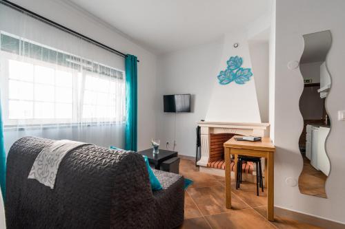 a living room with a couch and a table at Casa Alegria by CosyCasa Praia Peniche in Peniche