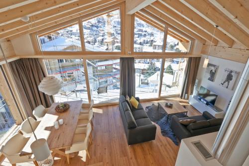 an overhead view of a living room with a large window at Hörnligrat Apartments in Zermatt