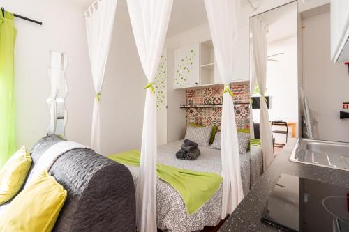a bedroom with two beds with mosquito nets at Casa Alegria by CosyCasa Praia Peniche in Peniche