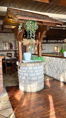 a stone wall with a planter with plants in it at Hotel Olimpija plus in Herceg-Novi