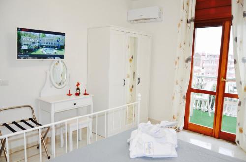 a white bathroom with a sink and a mirror at Relais Bellavista B&B in Casalnuovo di Napoli