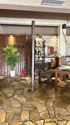 a patio with a wooden table and a bench at Hotel Olimpija plus in Herceg-Novi