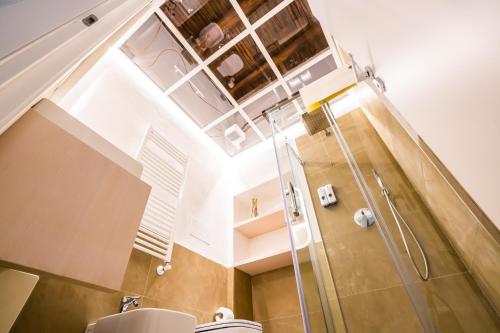 a bathroom with a shower and a toilet at Vinto House Salerno Old Town in Salerno