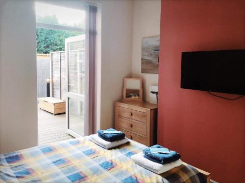 a bedroom with two beds and a flat screen tv at Richmond Luxury flat Fabulous location in Southend-on-Sea